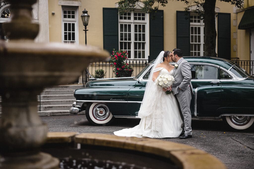 Bride and groom portraits in front of a classic car at the Mansion of Oyster Bay